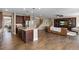 Open-concept living area with a spacious kitchen island, comfortable seating, and a staircase at 228 Horizon Ave, Erie, CO 80516
