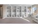 Bright open loft featuring custom built-in shelving and natural light perfect for relaxing or working from home at 228 Horizon Ave, Erie, CO 80516