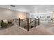 Upstairs loft space offering a comfortable sitting area and view of downstairs at 228 Horizon Ave, Erie, CO 80516