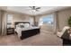 Relaxing main bedroom with tray ceilings, ceiling fan, ample natural light, and stylish decor at 228 Horizon Ave, Erie, CO 80516