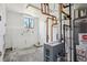 Functional basement with exposed pipes, hot water tank, and mechanical equipment at 2633 Mather St, Brighton, CO 80601
