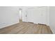Neutral bedroom features light wood floors, neutral walls, and a window at 2633 Mather St, Brighton, CO 80601