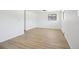 Bedroom with a window and light wood flooring; neutral walls, baseboard heating at 2633 Mather St, Brighton, CO 80601
