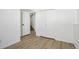 Neutral bedroom featuring light wood flooring, white walls, and closet storage at 2633 Mather St, Brighton, CO 80601