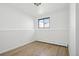 Light and bright bedroom with neutral walls, light wood flooring, and baseboard heating at 2633 Mather St, Brighton, CO 80601