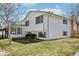 Charming two-story home with white siding, gray trim and a well-manicured front lawn at 2633 Mather St, Brighton, CO 80601