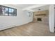 Bright living room featuring a fireplace, large windows, and light wood flooring at 2633 Mather St, Brighton, CO 80601