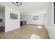 Spacious living room with open layout, wood-look floors, and abundant natural light at 2633 Mather St, Brighton, CO 80601