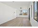 Bright sunroom with large windows, light wood floors and white walls offers a tranquil space at 2633 Mather St, Brighton, CO 80601