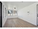 Bright sunroom with large windows, light wood floors and white walls offers a tranquil space at 2633 Mather St, Brighton, CO 80601