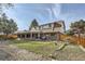 View of the backyard and rear exterior showing a patio, lawn and partial fence at 8633 E Monmouth Pl, Denver, CO 80237