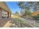 Expansive backyard with a manicured lawn, mature trees, and privacy fencing at 8633 E Monmouth Pl, Denver, CO 80237
