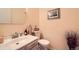 Powder bath featuring a modern sink, toilet, decorative items and neutral wall paint at 8633 E Monmouth Pl, Denver, CO 80237