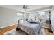 Bedroom with wood floors, natural light, ceiling fan, and light grey paint at 8633 E Monmouth Pl, Denver, CO 80237