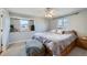 Bedroom featuring natural light, a ceiling fan, and a comfortable bed with neutral tones at 8633 E Monmouth Pl, Denver, CO 80237