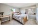 Bedroom featuring a light color palette, neutral decor, natural light and a wooden bed frame at 8633 E Monmouth Pl, Denver, CO 80237