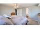 Bedroom with neutral colors, ceiling fan and view into an ensuite bathroom at 8633 E Monmouth Pl, Denver, CO 80237