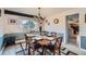 Charming dining room with stylish lighting, a large window, and seating for six at 8633 E Monmouth Pl, Denver, CO 80237