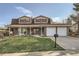 Charming two-story brick home with a well-maintained lawn and attached two-car garage at 8633 E Monmouth Pl, Denver, CO 80237