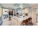 Modern kitchen featuring granite countertops, stainless steel appliances, and a breakfast bar at 8633 E Monmouth Pl, Denver, CO 80237
