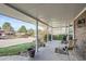 Inviting covered porch with seating area perfect for relaxing and enjoying neighborhood views at 8633 E Monmouth Pl, Denver, CO 80237