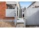 A fenced entrance to the backyard with an outdoor staircase leading to the units at 160 Jackson St # 5, Denver, CO 80206