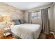 Inviting bedroom featuring exposed brick, natural light, and wood floors at 160 Jackson St # 5, Denver, CO 80206