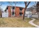 Brick building with awnings and mature trees, sidewalk leads around home at 160 Jackson St # 5, Denver, CO 80206