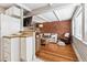 Inviting living room featuring exposed brick wall, wood floors, and comfortable seating with lots of natural light at 160 Jackson St # 5, Denver, CO 80206