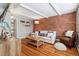 Inviting living room featuring exposed brick wall, wood floors, and comfortable seating arrangement with lots of natural light at 160 Jackson St # 5, Denver, CO 80206