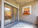 Cozy balcony with sliding glass doors and a window box filled with colorful flowers at 8378 S Upham Way # A102, Littleton, CO 80128