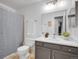 Bathroom with a shower and bathtub combination, a large mirror, and a neutral color scheme at 8378 S Upham Way # A102, Littleton, CO 80128