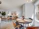 Dining area with a round table, stylish chairs, and bright natural light from the window at 8378 S Upham Way # A102, Littleton, CO 80128