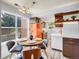 Bright kitchen featuring a round dining table, stylish chairs, and a unique orange refrigerator at 8378 S Upham Way # A102, Littleton, CO 80128