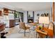 Cozy living room with a fireplace, stylish furniture, and a sliding door to the outside at 8378 S Upham Way # A102, Littleton, CO 80128