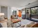 Spacious living room showcasing an open floor plan with a dining area and sliding glass doors at 8378 S Upham Way # A102, Littleton, CO 80128