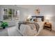 Inviting bedroom with a comfortable bed, stylish decor, and a large window with a view at 8378 S Upham Way # A102, Littleton, CO 80128