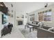 Cozy living room featuring a stone fireplace, comfortable seating, and plenty of natural light at 5465 Tall Spruce St, Brighton, CO 80601