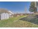 Lush backyard featuring green grass, a wooden fence, and a storage shed at 21367 E Aberdeen Dr, Centennial, CO 80015
