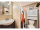 Cozy bathroom featuring a vanity with a designer mirror and a toilet with overhead storage at 21367 E Aberdeen Dr, Centennial, CO 80015