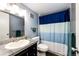 Bathroom with a vanity, granite counter, and a blue and white shower curtain at 2459 S Xanadu Way # B, Aurora, CO 80014