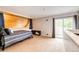 Bedroom featuring wooden accent wall, bed, walk out slider to balcony at 2459 S Xanadu Way # B, Aurora, CO 80014