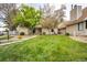 Well-maintained townhouse with manicured lawn and mature trees in a quiet, suburban neighborhood at 2459 S Xanadu Way # B, Aurora, CO 80014