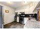 Well-lit kitchen featuring stainless steel appliances, white cabinetry, and granite countertops at 2459 S Xanadu Way # B, Aurora, CO 80014