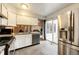 Modern kitchen with white cabinets, stainless steel appliances, and sliding glass door to the patio at 2459 S Xanadu Way # B, Aurora, CO 80014