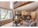 Cozy living room features a large window, modern lighting, and comfortable seating at 2459 S Xanadu Way # B, Aurora, CO 80014
