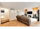 Comfortable living room featuring wood-beam ceilings, brick fireplace, and an open floor plan at 2459 S Xanadu Way # B, Aurora, CO 80014