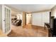 Spacious room with living room in the view, offering a glimpse of a kitchen and laundry area at 2459 S Xanadu Way # B, Aurora, CO 80014