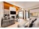 Cozy living room with stone fireplace, wood-beam ceilings, and comfortable seating with sliding glass door at 2459 S Xanadu Way # B, Aurora, CO 80014