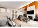 Inviting living room featuring a brick fireplace, mounted TV, comfortable sofas and French Doors at 2459 S Xanadu Way # B, Aurora, CO 80014